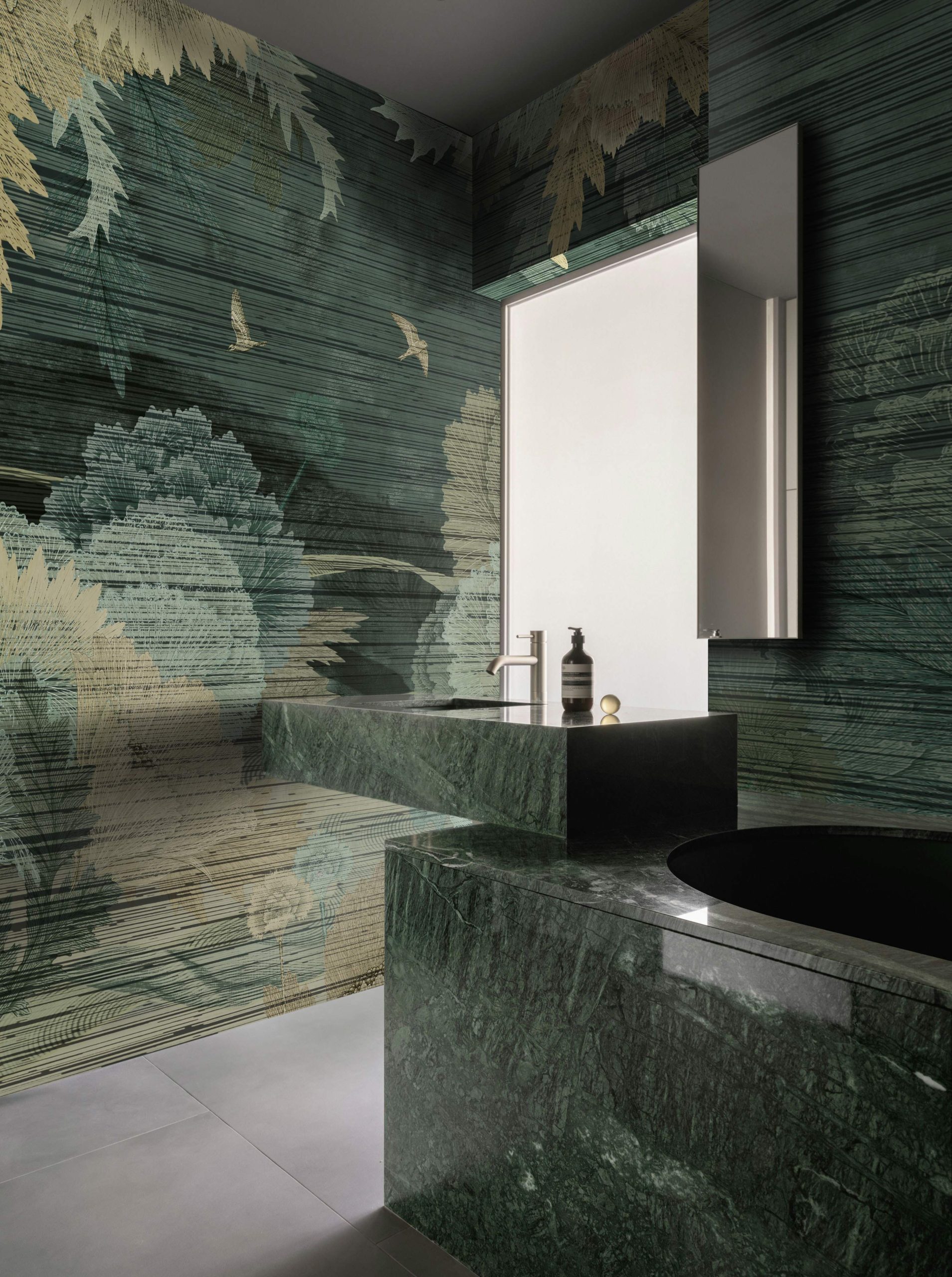 The Miori Japanese-inspired botanical wallcovering in a sophisticated bathroom with rich green marble.